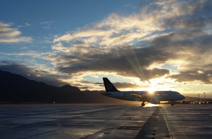 silhouette of airplane in golden hour